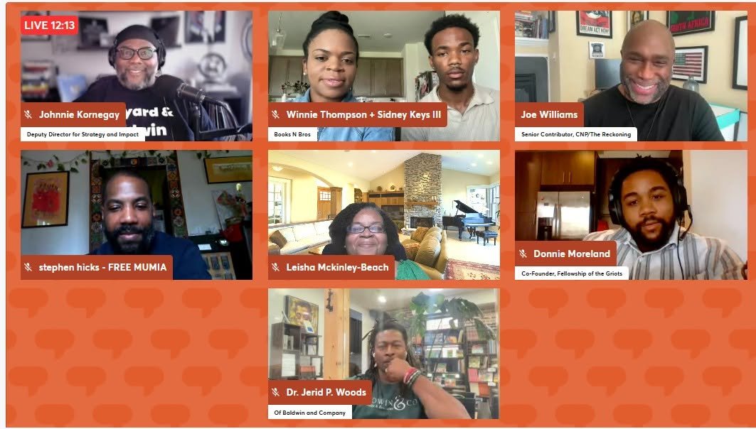 Screenshot of a virtual panel with many participants on video.